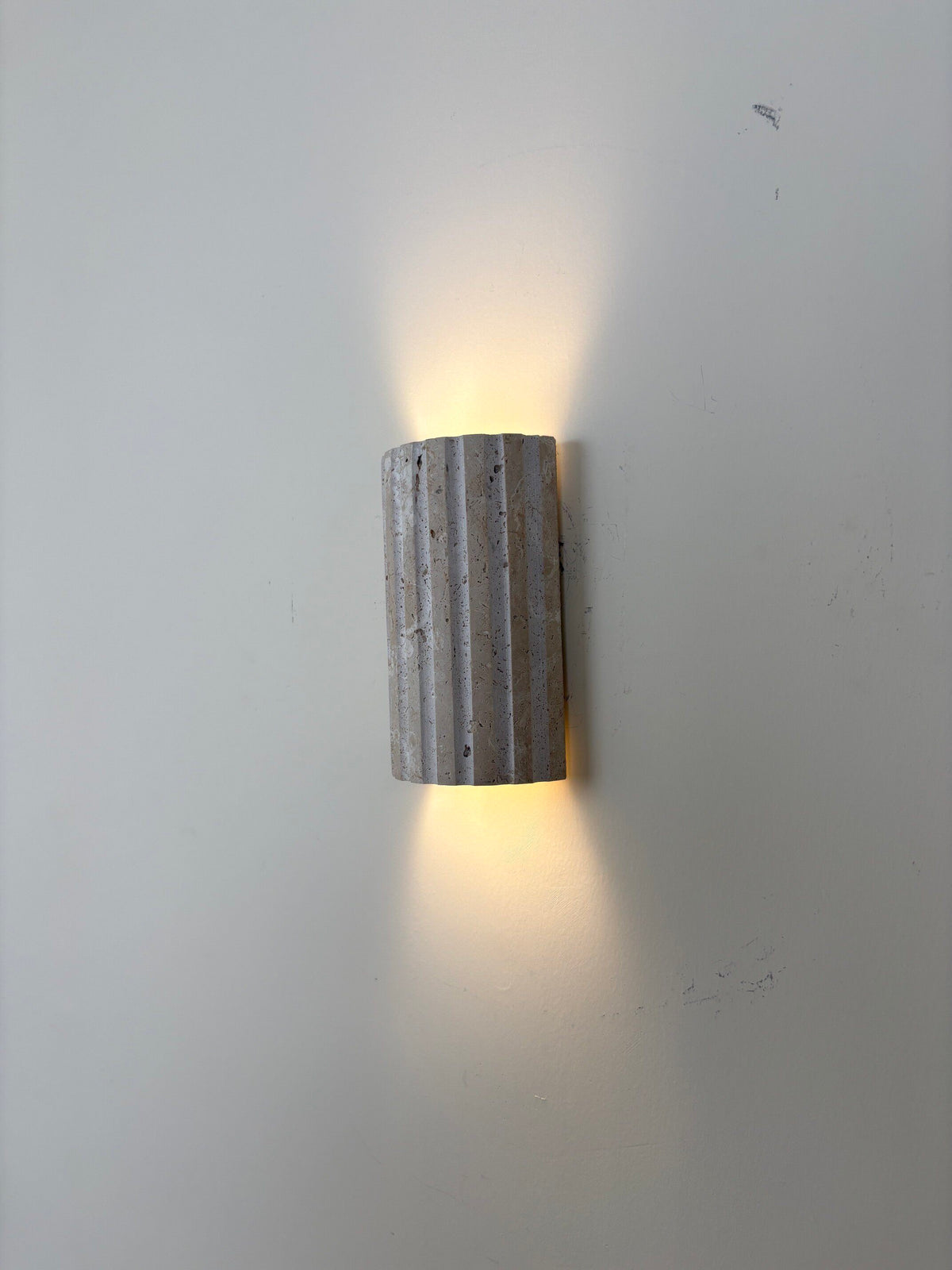 Solaro compact stone outdoor wall light with dual-direction lighting